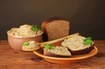 Fresh pate with bread on wooden table
