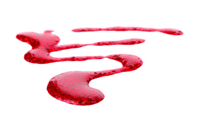 Red nail polish drops isolated on white