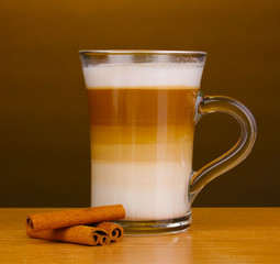Fragrant сappuccino latte in glass cup and cinnamon