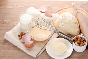 Fototapeta na wymiar Ingredients for dough on wooden table