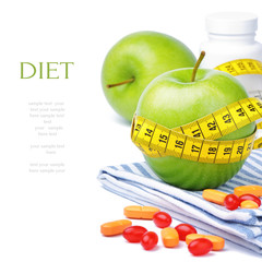 Green apples, vitamins and measuring tape
