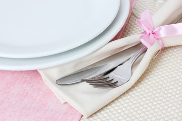 Table setting with fork, knife, plates, and napkin