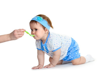 Cute baby girl eating isolated on white