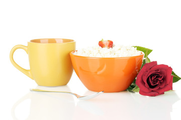 cottage cheese with strawberry in orange bowl and orange cup