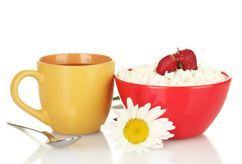 cottage cheese with strawberry in red bowl and orange cup with