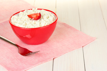 cottage cheese with strawberry in red bowl and fork
