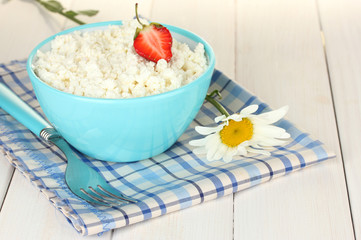 cottage cheese with strawberry in blue bowl and fork