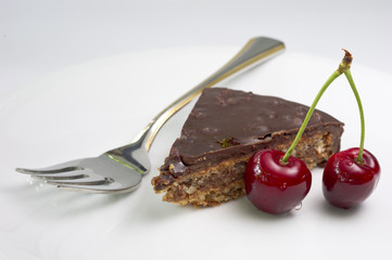 Chocolate cake with a pair of cherry