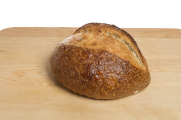 Loaf of bread on wooden board