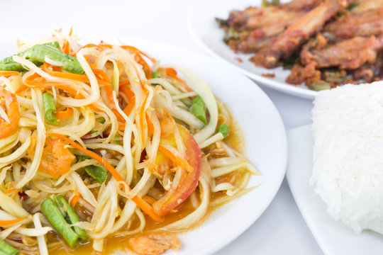 Spicy green papaya salad with fried chicken and rice,  Thai cuis