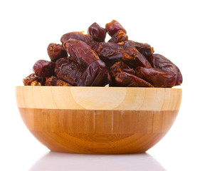 delicious dried dates in wooden bowl isolated on white