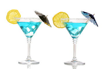 Blue cocktail in martini glasses isolated on white
