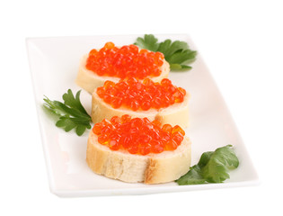 Red caviar on bread on white plate isolated on white