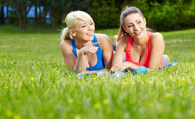 Two smiling fitness girls outdoor