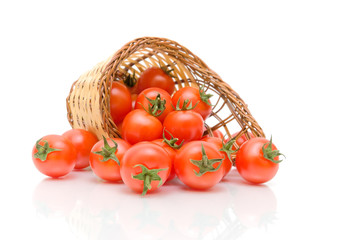 red cherry tomatoes in a basket on a white background