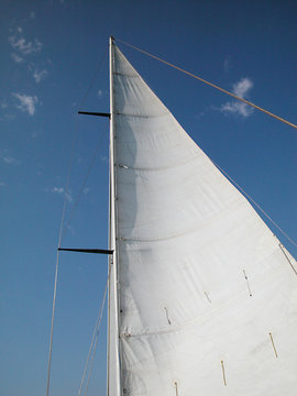 White sail on blue sky