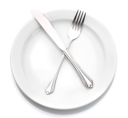 White empty plate with fork and knife isolated on white