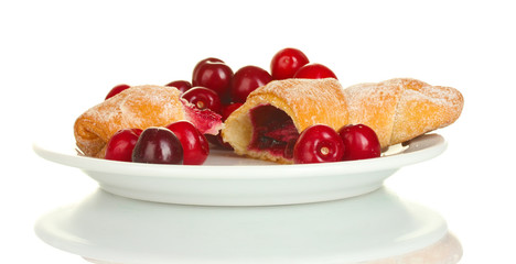white plate with croissant and cherry isolated on white