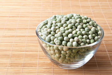 glass bowl full of green peas