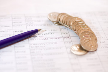 pen and  coins on business paper