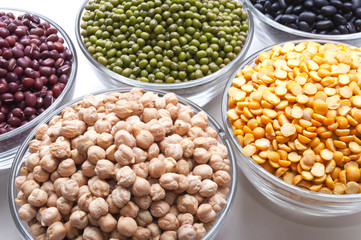 glass bowls with legumes on white
