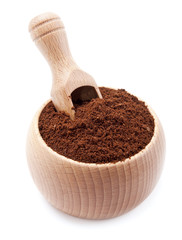 ground coffee in a wooden bowl with scoop