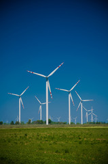 Wind turbine farm on rural terrain