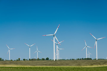 Wind turbine farm on rural terrain