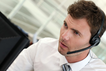 Portrait of salesman with headset on