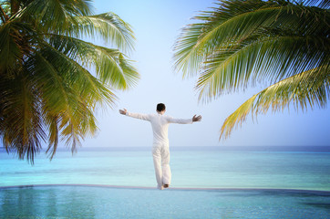 Man standing at Luxury tropical Infinity Pool (Maldives)