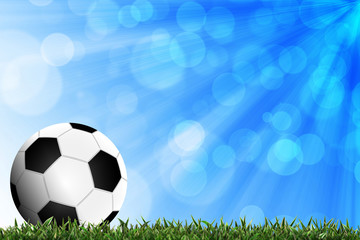 Fototapeta premium Football in green grass with background colorful