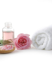 Obraz na płótnie Canvas Rose flowers and massage lotion, Spoon of spa salt