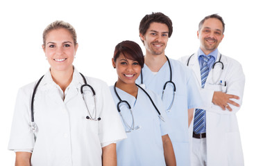 Fototapeta premium Group of doctors standing together over white