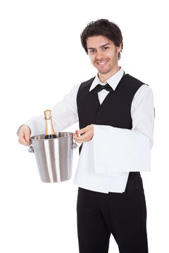 Portrait of a butler with bottle of champagne