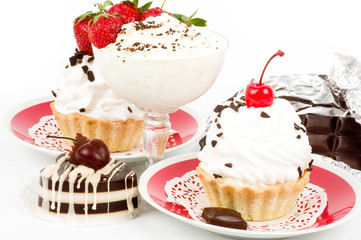 Dessert - sweet cake with strawberry and cherry on a plate