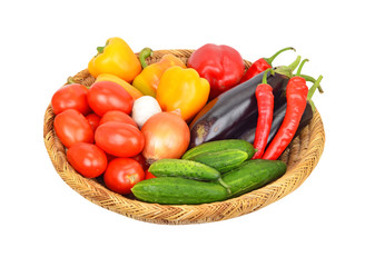 Vegetables in a wattled basket, isolated on white background