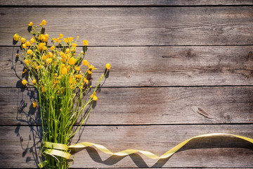 yellow flowers on wooden background