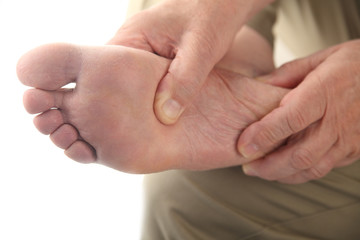 a man checks his aching foot