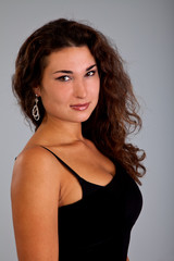 Fototapeta premium Portrait of beautiful woman with cute earrings isolated on black