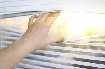 hand in blinds