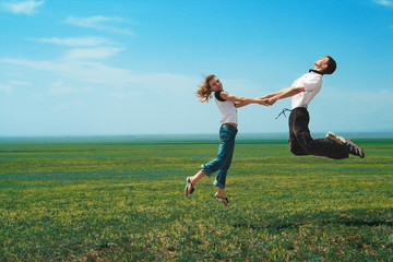 Fun couple in jump on the field