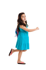 Little school girl with backpack walking isolated on white