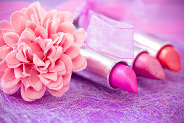 Obraz na płótnie Canvas glamour lipsticks and flower petals