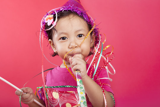 Cute Girl Blowing Party Horn