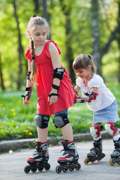 Sisters skating in park