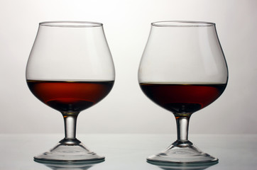 Two glasses of cognac isolated on white