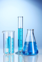 Laboratory glassware with blue liquid with reflection