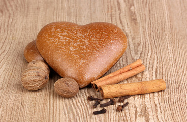 Heart-shaped cookies with cinnamon, nutmegs and carnation