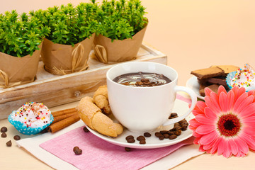 cup of coffee and gerbera  beans, cinnamon sticks