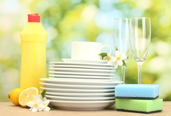 empty clean plates, glasses and cups with dishwashing liquid,